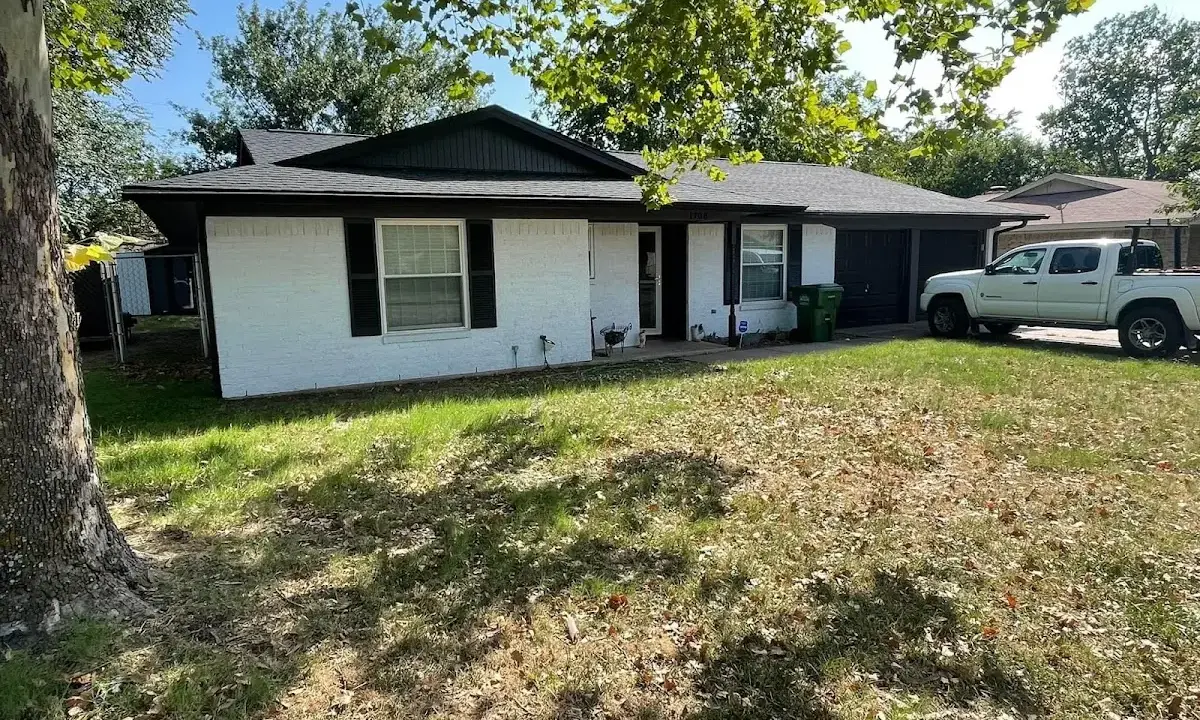 Professional roofing crew working on a residential roof in Emporia